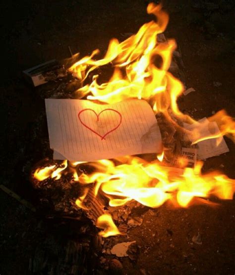 A Piece Of Paper With A Heart Drawn On It Sitting In The Middle Of Fire