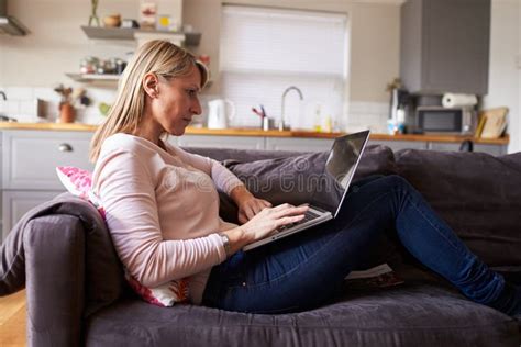Woman Relaxing On Sofa Using Laptop In Modern Apartment Stock Image Image Of Lifestyle