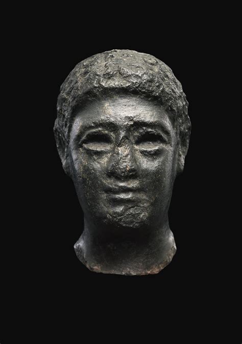 An Egyptian Basalt Head Of A Man Late Ptolemaic Period Circa 100 30 B