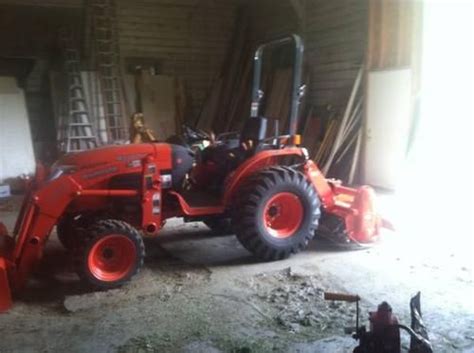 A Red Tractor Parked Inside Of A Garage