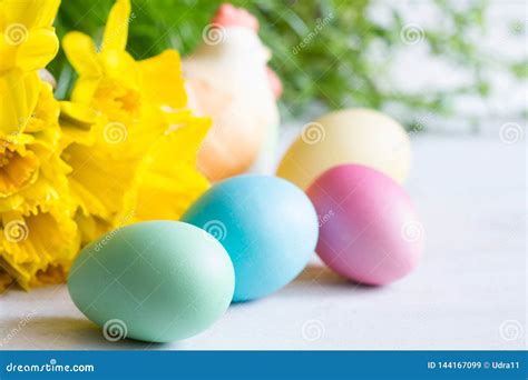Spring Daffodils And Colorful Easter Eggs On Blurred Background Stock