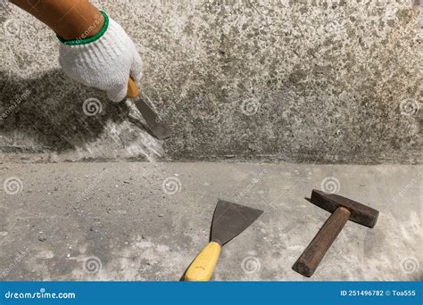 Renovation Home Painter Scraping Concrete Debris On Wall From