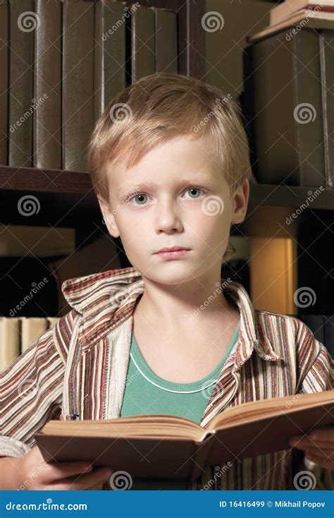 The Boy Reads The Book With A Serious Kind Stock Image Image Of