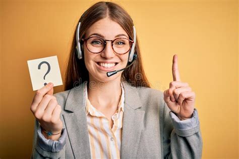 Young Redhead Call Center Agent Woman Using Headset Holding Question