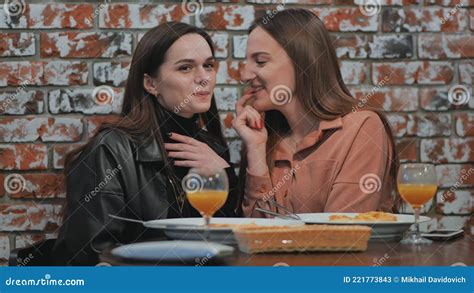 Young And Cheerful Girls Gossip And Whisper To Each Other While Sitting In A Cafe Stock Video