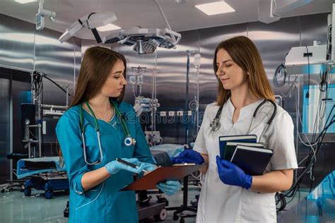 Two Beautiful Young Nurses Are In The Operating Room Stock Image
