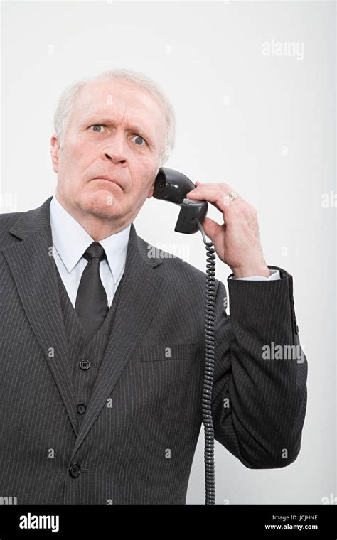 A Confused Businessman Using A Telephone Stock Photo Alamy