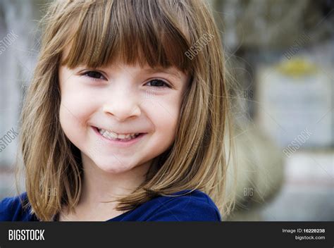 Portrait Of A Pretty Little Girl With Bright Smile Stock Photo And Stock