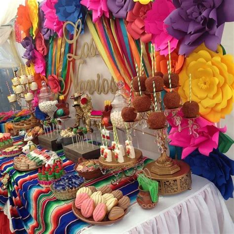 a colorful dessert table with lots of food on it