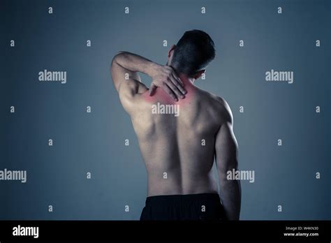 Young Muscular Fit Man Touching And Grabbing Neck And Upper Back
