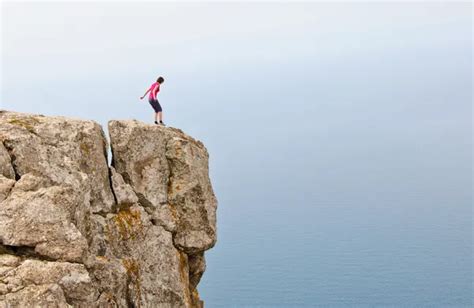 Lonely Woman Standing On The Edge Of The Cliff Stock Image Everypixel
