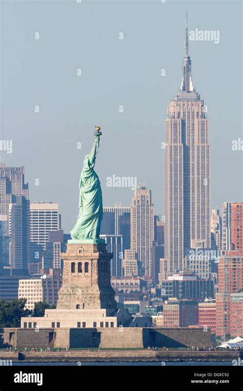 A Skyline View Of The Statue Of Liberty The Empire State Building