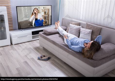 Woman Lying On Sofa Watching Television Stock Image PantherMedia Stock Agency