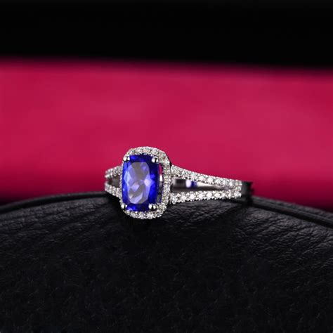 A 2 carat diamond ring is a stunning symbol of commitment. 2 Carat cushion cut Sapphire and Diamond Halo Engagement Ring in White Gold - JeenJewels