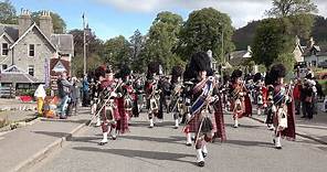 Massed Pipes and Drums march to the 2019 Braemar Gathering in Royal Deeside, Aberdeenshire, Scotland