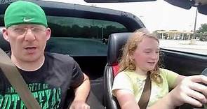 Kid takes her Corvette for a drive