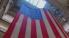 Macy's raise world's largest American flag inside State Street store