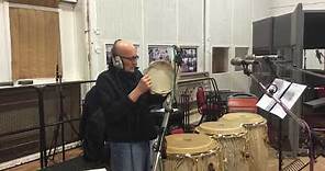 Ray Cooper plays the tambourine.