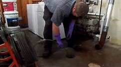 How to use a sewer snake to unplug a clogged drain pipe