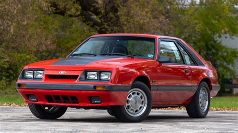 A 1985 Ford Mustang GT in black with red accents, showcasing its aggressive and popular Fox Body styling