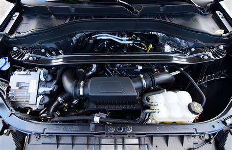 Mechanic performing maintenance on a 2020 Ford Explorer ST engine