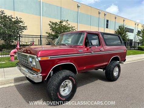 Mechanic performing routine maintenance on a 79 Ford Bronco for sale.