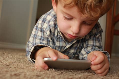 Child playing games on phone with parent