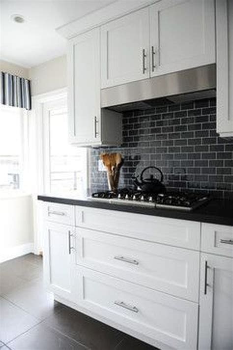 black backsplash white cabinets