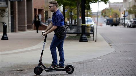 Electric scooter riding on sidewalk