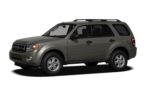 A person browsing a car listing website on a laptop, looking for a 2011 Ford Escape for sale