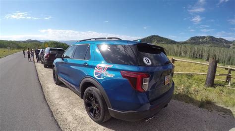 Ford Explorer ST navigating a scenic road with a confident stance, showcasing its driving dynamics