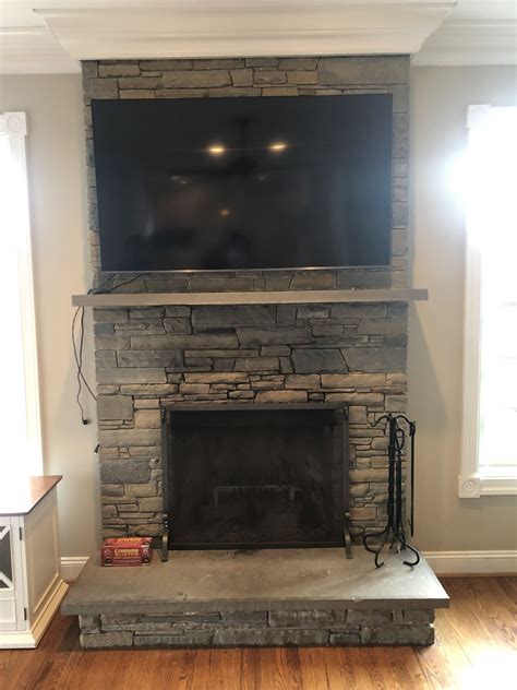 tv on stone fireplace